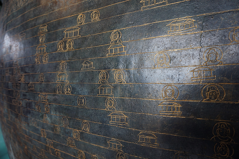 A close-up of engravings that decorate the pedestal of the Great Buddha statue.