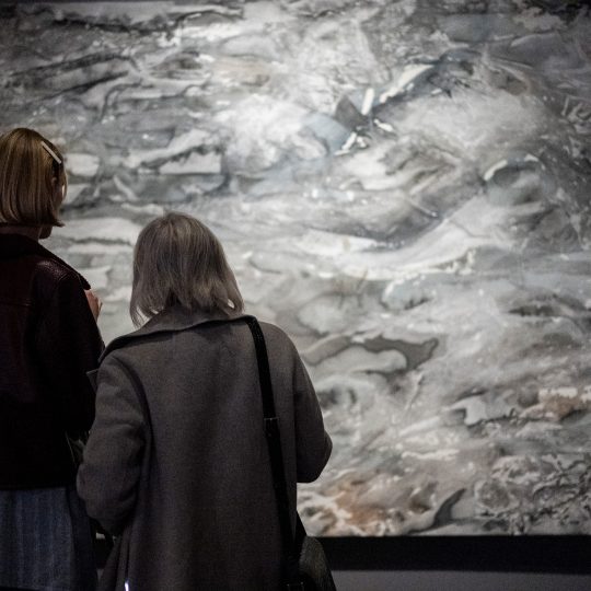 Gallery visitors view a large painting by Issy Wilson at PAGODA RED.