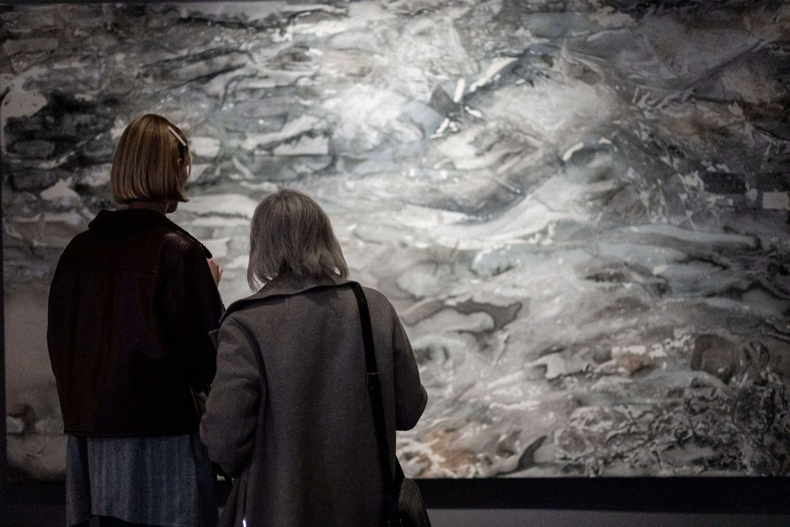 Gallery visitors view a large painting by Issy Wilson at PAGODA RED.